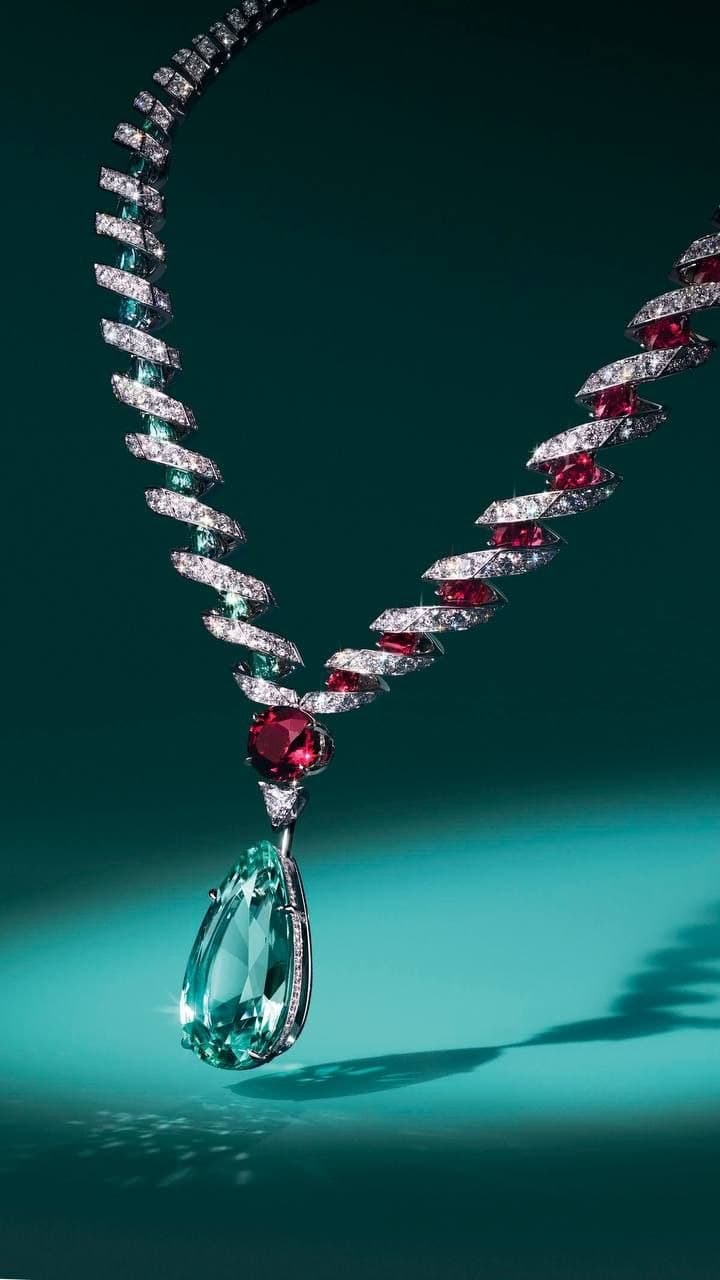 Aquamarine drop necklace with ruby spiral links on deep teal