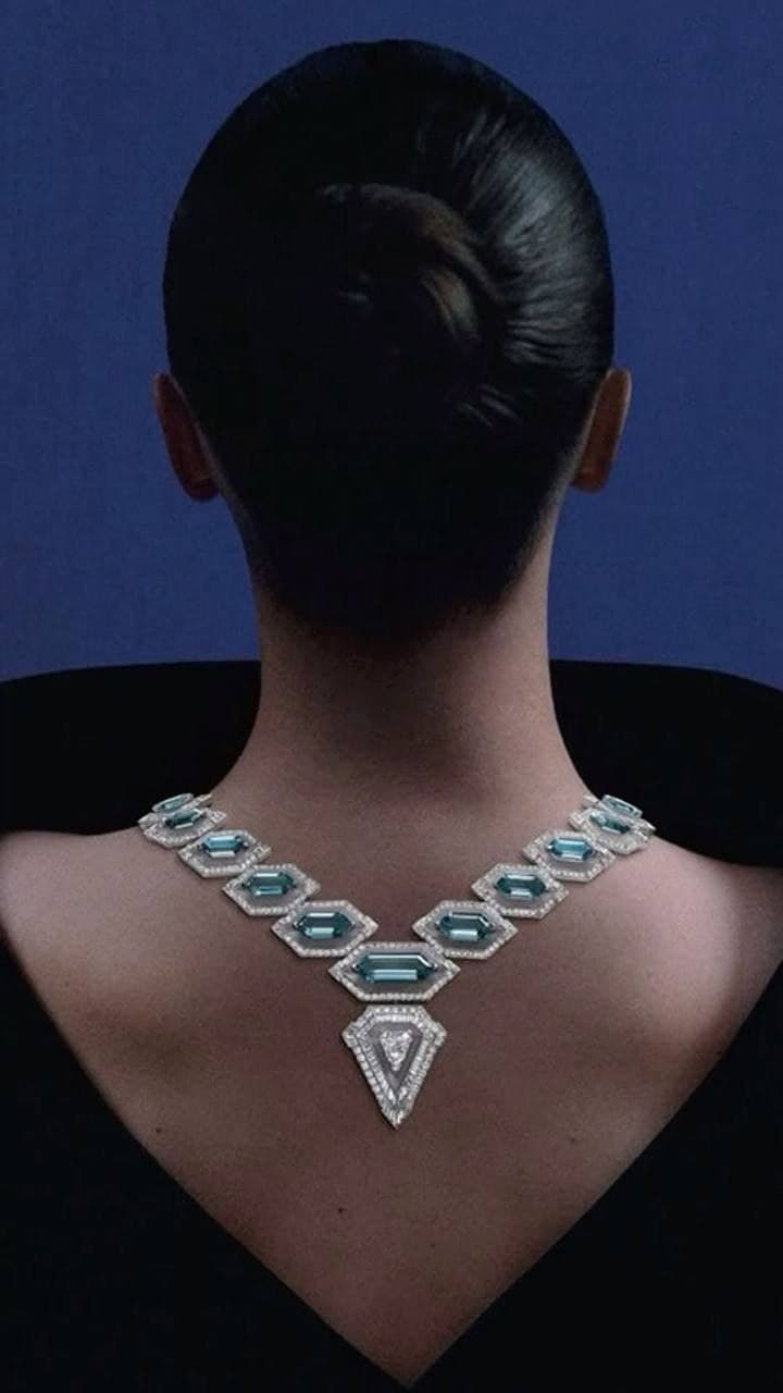 Aquamarine necklace worn down the nape by lamplight
